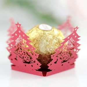 Laser-cut red Christmas tree hollow cupcake wrappers with snowflake and star motifs