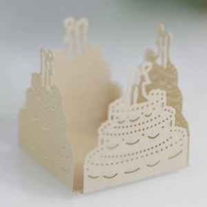 Laser cut ivory cake wrapper with bride and groom silhouette for wedding favors