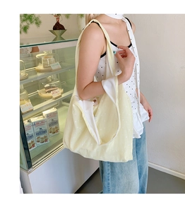 Close-up of cream floral canvas tote bag showing soft texture and large capacity