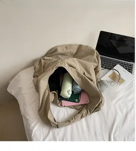 Interior view showing spacious storage capacity of a khaki tote bag with daily items