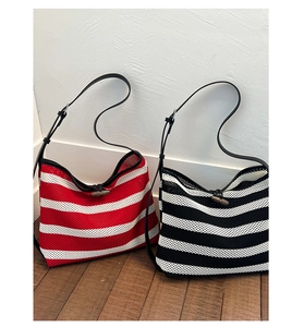 Detail of woven striped tote bags with breathable mesh and wooden toggle closure