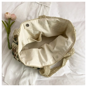 Detailed view of the woven tote bag featuring canvas lining and magnetic snap closure