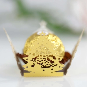 Macro detail of laser-cut Christmas tree chocolate holder in gold pearlescent paper
