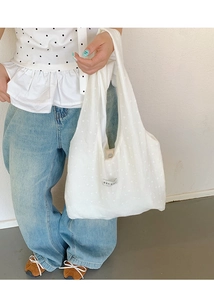 Detail of white floral embroidered canvas tote bag with Korean minimalist design label