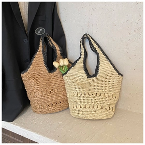Close-up of woven straw bags with hollow details and wave pattern edges for summer beach wear