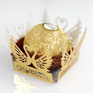 Laser-cut golden paper chocolate wrap with hollow swan wing design for wedding decor