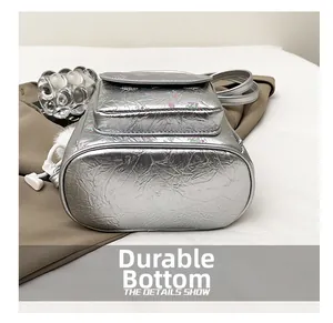 Detail shot of the wear-resistant bottom on this silver metallic floral backpack