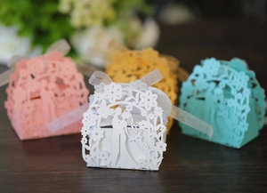 Detailed laser-cut wedding favor boxes with romantic silhouette and ribbon bows in multi-colors