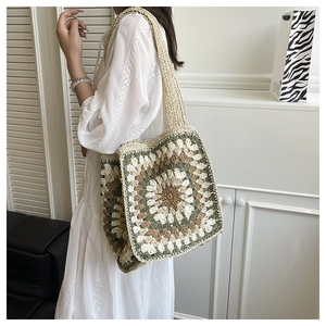 Detailed close-up of handmade crochet tote bag featuring vintage granny square patterns