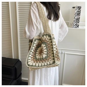 Detail of bohemian crochet tote bag showing concentric floral knit and wide shoulder strap