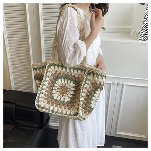 Detail of bohemian hand-woven crochet tote bag featuring multi-colored sunflower patterns