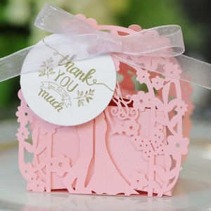 Pink laser-cut wedding favor box with floral patterns and a Thank You hang tag