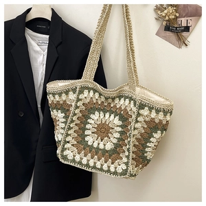 Macro detail of hand-crocheted tote bag featuring colorful geometric granny squares