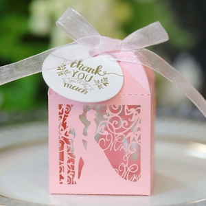 Pink laser-cut wedding favor box with Mr & Mrs silhouette and Thank You ribbon tag