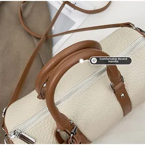 Detail of comfortable round handles and pebbled texture on stylish retro barrel bag