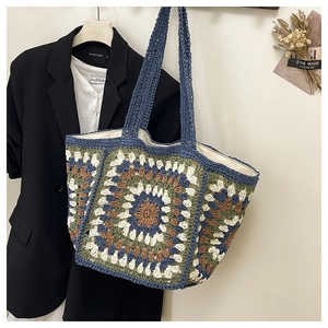 Detail of handmade granny square crochet tote bag with blue and green flower patterns