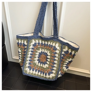 Detailed texture of handmade granny square crochet tote bag with fabric lining