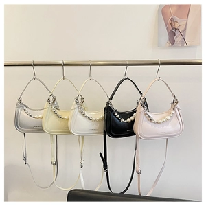 Detailed view of fashionable crescent underarm bags with pearl and chain decoration