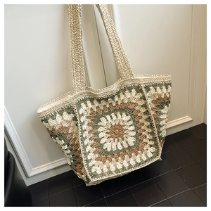 Detailed close-up of handmade crochet sunflower tote bag with floral knit pattern
