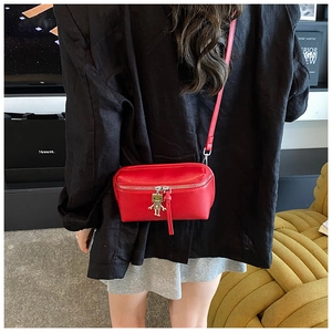 Mini red rectangle crossbody bag with metal robot charm and slim leather strap