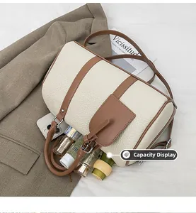 Top view of cream Boston bag interior showing spacious capacity for phone and cosmetics