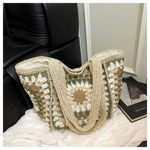 Close-up of handmade crochet tote bag featuring floral granny square patterns and woven handles