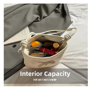 Internal view of cream bow bucket bag showing spacious storage for makeup and daily items