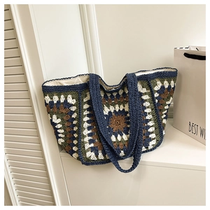 Detail of the vintage handmade crochet tote bag featuring granny square patchwork and canvas lining