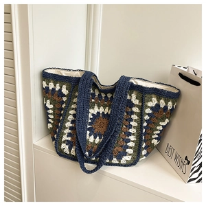 Detail shot of a handmade crochet tote bag featuring colorful granny square patterns and lining