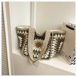 Detailed view of bohemian crochet tote bag with olive green grandmother square patterns