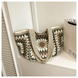 Detail of crochet tote bag with sunflower pattern and wide woven shoulder straps