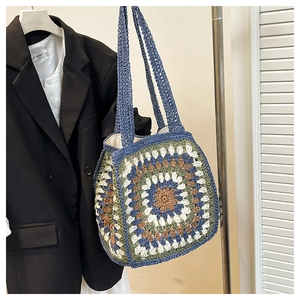 Close-up of handmade crochet tote bag with colorful retro floral patterns and cotton lining