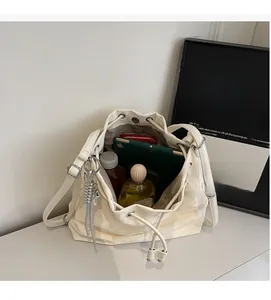 Spacious interior of cream bucket bag showing tablet, wallet and daily essentials