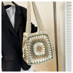 Macro view of floral crochet patterns and cotton texture on this granny square tote bag