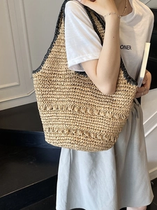 Summer woven straw tote bag with black trim and large capacity for beach vacations