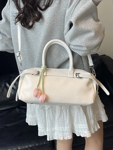 White litchi pattern leather baguette bag with pink tulip flower charm and strap