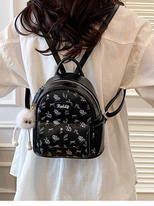 Mini zaino nero con motivi floreali e fiocchi, incluso ciondolo a forma di mostro