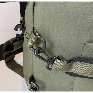 Detail view of army green outdoor backpack with durable nylon straps and sturdy plastic hooks
