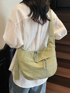 Light green crescent canvas crossbody bag with double woven zippers for women