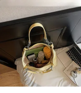 Interior view of large capacity yellow tote bag showing storage space for daily items
