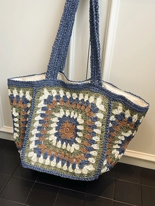Handmade granny square crochet tote bag with wide handles and bohemian weaving style