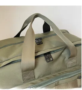 Macro shot of durable dark green travel bag with reinforced webbing handles and zipper