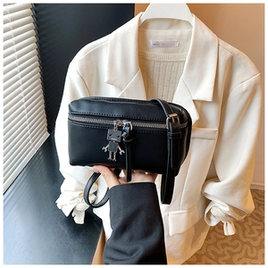 Detail of black mini box bag with smooth PU leather and cute robot metal charm