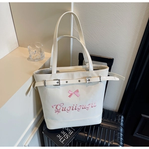 Détail du sac cabas crème avec décoration nœud rose et broderie Gugiigugii