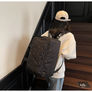 Detail of multi-functional black outdoor backpack with D-rings and side elastic cords