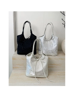 Three textured bucket bags with polka dots and butterfly patterns on marble steps