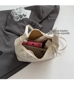 Top view of compact beige handbag interior showing phone, wallet and cosmetics capacity