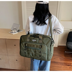 Back view of a large olive green travel backpack with multi-pocket design on a person