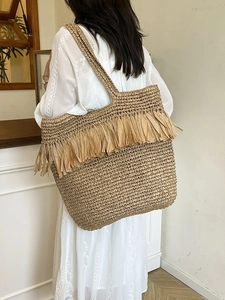 Handmade woven tote bag with fringe details, ideal for beach holidays and summer wear