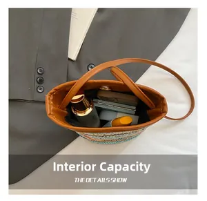 Detail view of woven straw bucket bag interior with cosmetics and magnetic closure